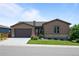 Beautiful one-story home featuring a manicured lawn, tasteful landscaping, and attached two-car garage at 11136 Sweet Cicely Dr, Parker, CO 80134