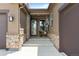 Charming front entrance featuring stone accents, covered porch and modern entry door at 11136 Sweet Cicely Dr, Parker, CO 80134