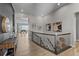 Well-lit upper hallway with hardwood floors and decorative wall art leading to the living area at 11136 Sweet Cicely Dr, Parker, CO 80134