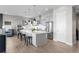 This kitchen features modern grey cabinets, stainless steel appliances, a large island, and hardwood floors at 11136 Sweet Cicely Dr, Parker, CO 80134