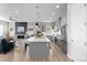 Open-concept kitchen features stainless appliances, a large island, and flows into the living area with a cozy fireplace at 11136 Sweet Cicely Dr, Parker, CO 80134