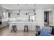 Modern kitchen boasts a large central island, stainless steel appliances, and sleek cabinetry at 11136 Sweet Cicely Dr, Parker, CO 80134