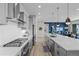 Well-equipped kitchen with stainless steel appliances, long island, and access to dining area at 11136 Sweet Cicely Dr, Parker, CO 80134
