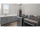 Well-equipped laundry room featuring modern washer and dryer, sink, and storage cabinets at 11136 Sweet Cicely Dr, Parker, CO 80134