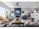 Cozy living area with fireplace, neutral colors, and seamless integration with the kitchen at 11136 Sweet Cicely Dr, Parker, CO 80134
