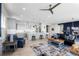 A bright, open-concept living area features wood floors, comfortable seating, and a kitchen with a large island at 11136 Sweet Cicely Dr, Parker, CO 80134