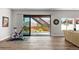 Bright living room features hardwood floors and sliding glass door to backyard with deck stairs at 11136 Sweet Cicely Dr, Parker, CO 80134