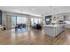 Open-concept living room featuring wood floors, fireplace, and seamless access to the dining and kitchen areas at 11136 Sweet Cicely Dr, Parker, CO 80134