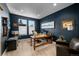 Stylish office with dark blue walls, a large desk, and comfortable seating at 11136 Sweet Cicely Dr, Parker, CO 80134