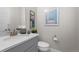Elegant powder room with a modern sink, toilet, and tasteful wall decor at 11136 Sweet Cicely Dr, Parker, CO 80134