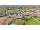Aerial view of a neighborhood adjacent to a golf course, showcasing well-maintained homes and lush greenery at 8468 Chase Dr, Arvada, CO 80003