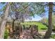 Charming backyard deck nestled among mature trees, offering serene golf course views and peaceful outdoor seating at 8468 Chase Dr, Arvada, CO 80003