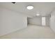 Expansive basement with neutral carpet and white walls, offering ample room for various activities at 8468 Chase Dr, Arvada, CO 80003