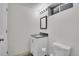 Bathroom features modern vanity, sleek mirror, updated lighting, and convenient toilet in a well-lit space at 8468 Chase Dr, Arvada, CO 80003