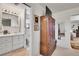 Bathroom featuring a vanity with lots of counter space, next to a walk-in closet with natural light at 8468 Chase Dr, Arvada, CO 80003
