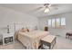 Serene bedroom with a plush floral patterned quilt, soft carpet, and ample natural light at 8468 Chase Dr, Arvada, CO 80003