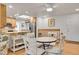 Cozy dining area features a round table, white chairs, skylight and an open view to the kitchen at 8468 Chase Dr, Arvada, CO 80003