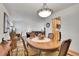 Warm dining area next to the kitchen with hardwood floors, a pendant light and a cozy ambiance at 8468 Chase Dr, Arvada, CO 80003