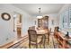 Traditional dining room with hardwood floors, a china cabinet and an adjacent view into the kitchen at 8468 Chase Dr, Arvada, CO 80003