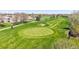 Scenic view of a meticulously maintained golf course, showcasing vibrant green fairways and a clear blue sky at 8468 Chase Dr, Arvada, CO 80003