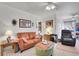 Cozy living room with tan sofa, green ottoman, and unique decor, creating a welcoming atmosphere at 8468 Chase Dr, Arvada, CO 80003