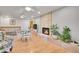 Open living area with a stone fireplace, hardwood floors, and a view to the dining area at 8468 Chase Dr, Arvada, CO 80003