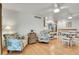 Open-concept living room features hardwood floors and floral furniture adding a touch of charm at 8468 Chase Dr, Arvada, CO 80003