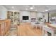 Open living space features a stone fireplace, built-in shelving and a bright seating area at 8468 Chase Dr, Arvada, CO 80003