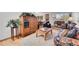 Inviting living room featuring a cozy floral sofa, wooden coffee table, and a decorative wooden armoire at 8468 Chase Dr, Arvada, CO 80003