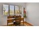 Bright home office with hardwood floors, desk, and large window offering natural light at 8468 Chase Dr, Arvada, CO 80003