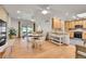 Bright, open floorplan with a kitchen leading into a dining area and living room with hardwood floors at 8468 Chase Dr, Arvada, CO 80003