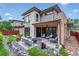Inviting backyard patio featuring comfortable seating, a fire pit, and modern design at 4274 E Dickenson Pl, Denver, CO 80222