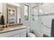 Bright bathroom with a glass-enclosed shower, modern fixtures, and white tile at 4274 E Dickenson Pl, Denver, CO 80222