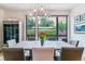 Elegant dining room with large window and modern light fixture at 4274 E Dickenson Pl, Denver, CO 80222
