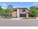 Modern home with a dark gray garage door and stone and tan siding at 4274 E Dickenson Pl, Denver, CO 80222