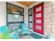 Inviting front porch with a vibrant red door and blue Adirondack chairs at 4274 E Dickenson Pl, Denver, CO 80222