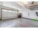 Spacious garage with a full-sized door, overhead storage, and a sealed concrete floor at 4274 E Dickenson Pl, Denver, CO 80222