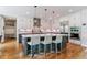 Bright kitchen with large island, breakfast bar, modern appliances and hardwood flooring at 4274 E Dickenson Pl, Denver, CO 80222
