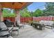 Covered patio showcasing a lounge set, barbecue, and outdoor fireplace with backyard views at 4274 E Dickenson Pl, Denver, CO 80222
