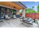 Covered patio featuring a stone pillar and an outdoor fireplace with backyard access at 4274 E Dickenson Pl, Denver, CO 80222