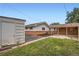 Large backyard with a shed, carport, gravel, and a grass lawn at 5563 Newland Way, Arvada, CO 80002