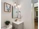 Bathroom featuring a modern vanity with brushed nickel hardware, art, and soft lighting at 5563 Newland Way, Arvada, CO 80002