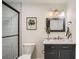 Charming bathroom featuring a modern vanity, toilet, decorative art, and shower at 5563 Newland Way, Arvada, CO 80002