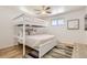 Bedroom features a bunk bed, hardwood flooring, a window, and neutral paint at 5563 Newland Way, Arvada, CO 80002