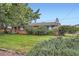 Home featuring a well-manicured lawn and mature landscaping at 5563 Newland Way, Arvada, CO 80002