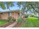 Brick home with roses, bushes, and green grass at 5563 Newland Way, Arvada, CO 80002