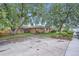 Charming brick ranch-style home with a spacious front yard and mature trees at 5563 Newland Way, Arvada, CO 80002