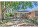 Charming brick home featuring a covered front porch with a small outdoor seating area at 5563 Newland Way, Arvada, CO 80002