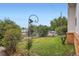 Landscaped front yard with a green lawn and mature shrubbery at 5563 Newland Way, Arvada, CO 80002