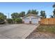 Detached two-car garage with neutral doors, a concrete driveway, and some landscaping, perfect for parking and storage at 5563 Newland Way, Arvada, CO 80002